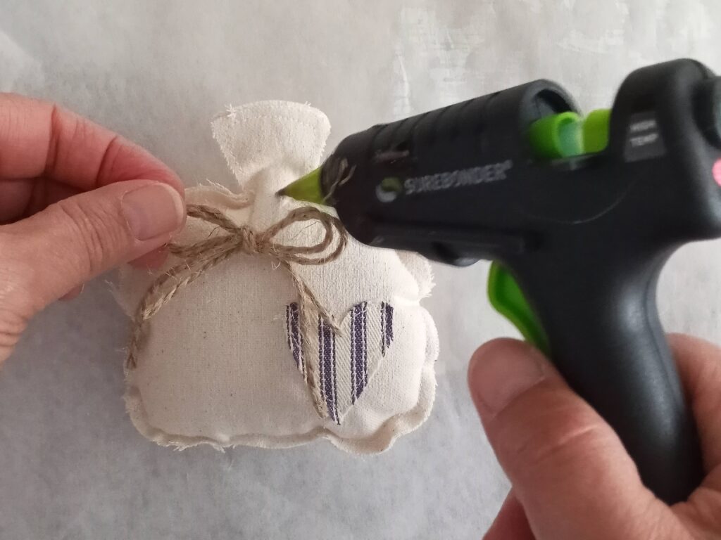 Adding jute bow with hot glue