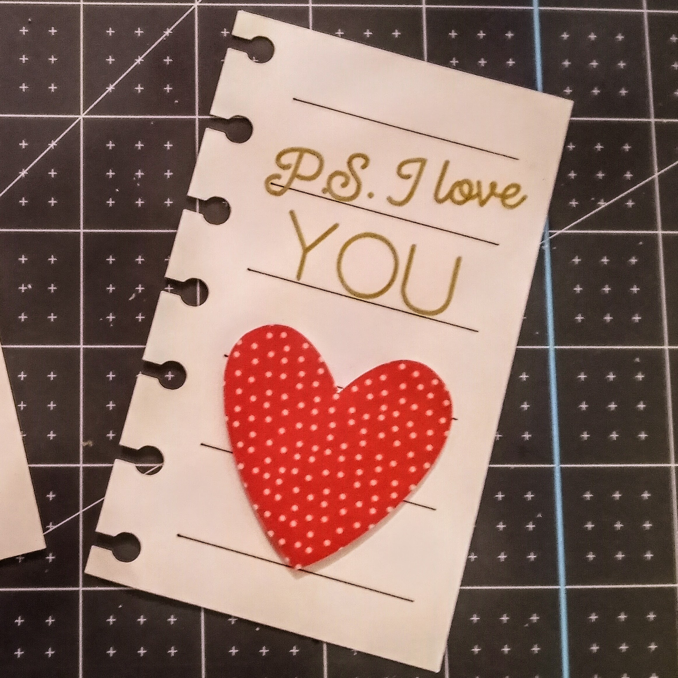 Mini notebook page with P.S. I love you written with Cricut Pen. A cardstock heart embellishes this Valentine's Day project. 